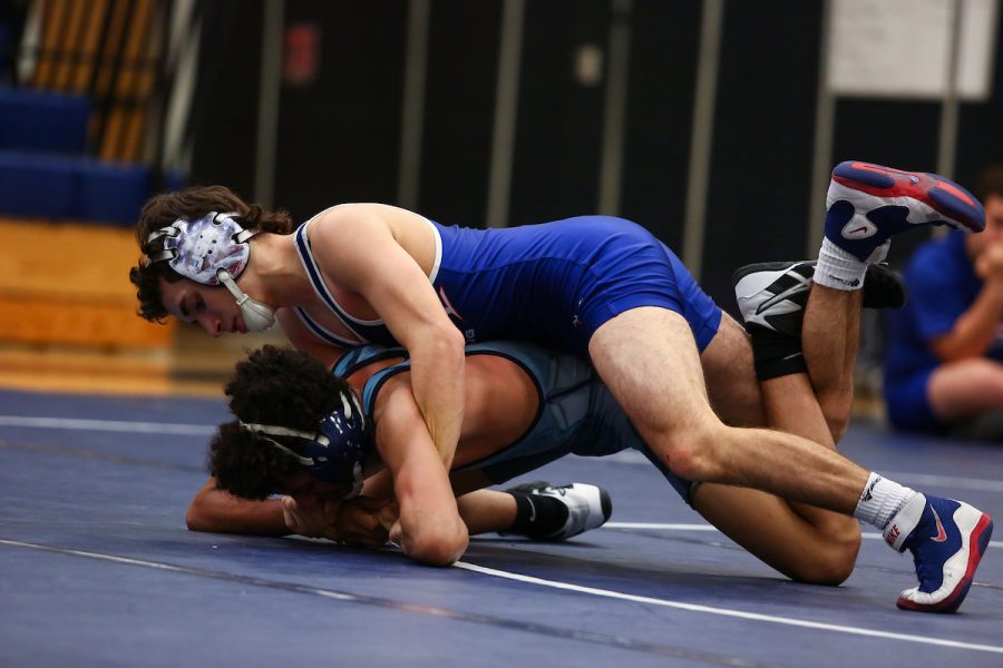 Senior Austin Harris is pinning down his opponent in his match.