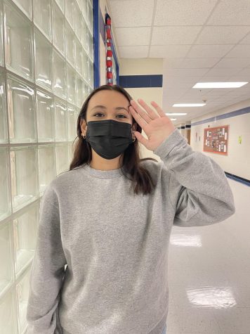 Freshman Gaby Alvarado signs hello. She is one of several students at LHS that advocates for the instruction in ASL. Photo by Bailie Stramer.