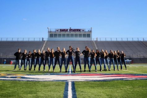 Partaking in their state competition tradition, the cheerleaders dress in black during their photo shoot in Eagle Stadium. Photo courtesy of Coach Waddle.