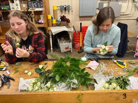 Hannah Winegardner and Meredith Day work on creating corsages and boutineers for prom. Photo courtesy of Mrs. Burton.