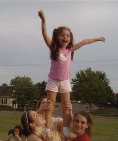 Joyce Quintela practices with the LHS cheer team over a decade ago. This year she graduates as a member of the class of 2022 having completed her own Eagle cheer career. Photo courtesy of Joyce Quintela.