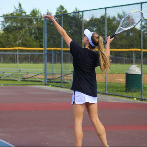Junior Hailey Marquis serves in one of her matches. She is one of several members that has praised the team and individual growth this season. Photo courtesy of LHS Tennis.