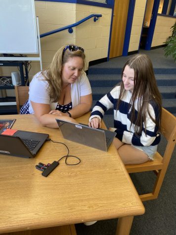 Ms. Larsen helps student Emily Campbell proofread her creative writing assignment. Photo by Susy Holbrook.